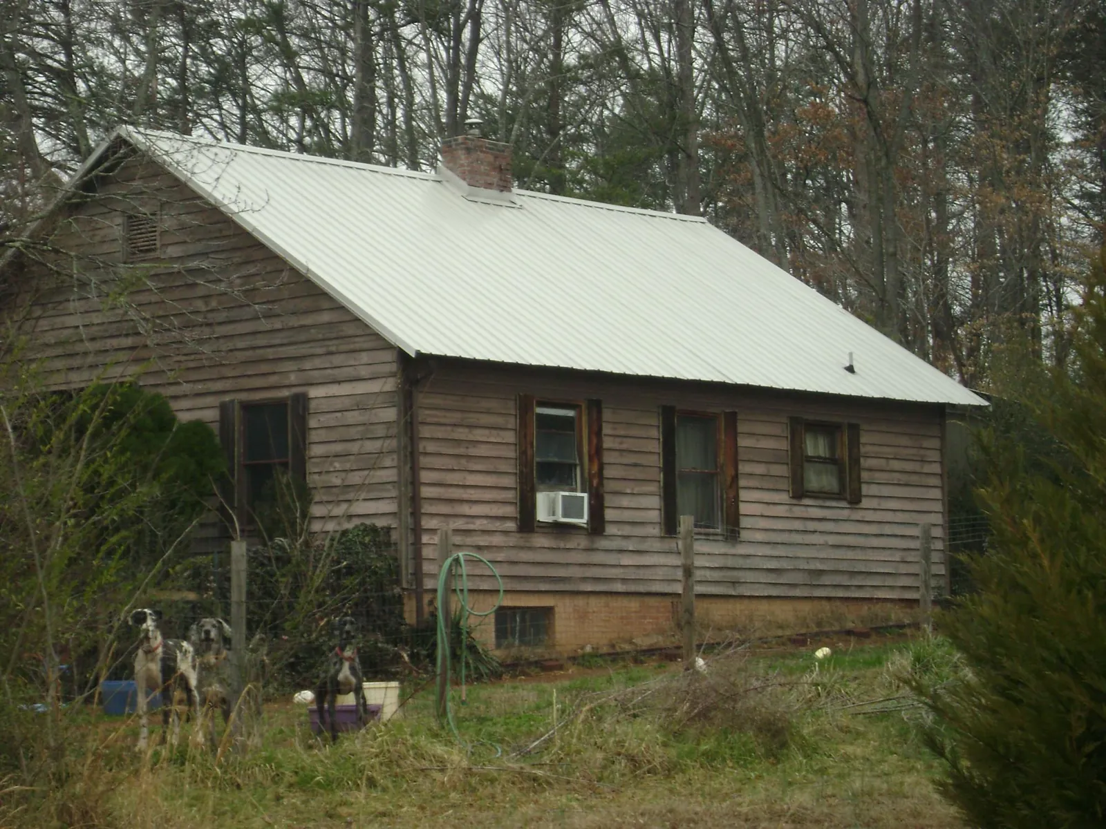White metal roof on an old wood sided farmhouse, from a Asphalt Shingle Roof Repair job in The Plains